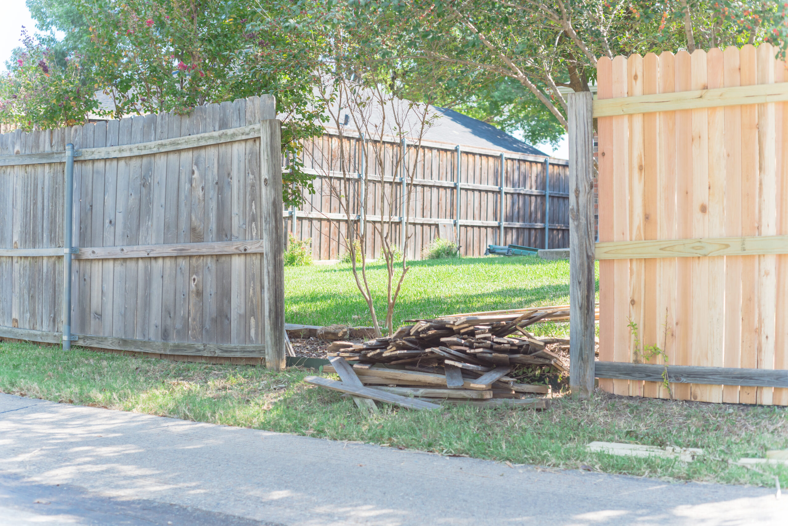 A wooden fence damaged from fall storms