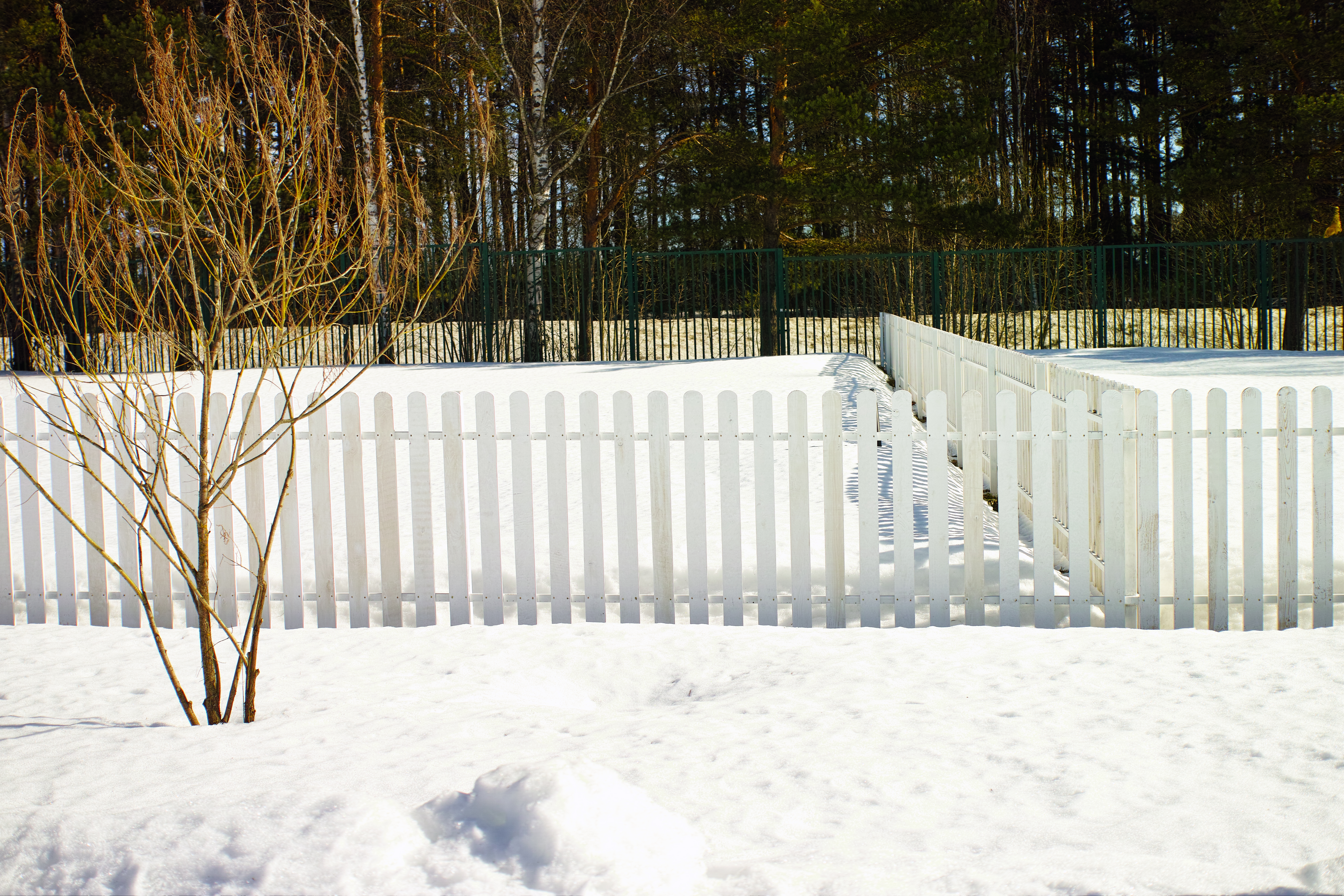 Home fence in snow prepared against winter